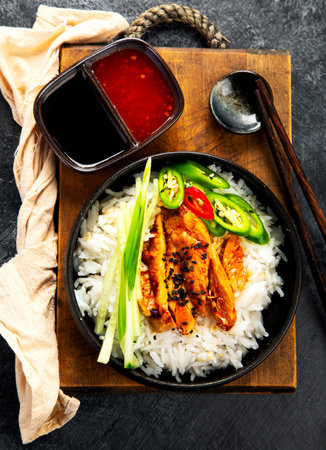 Crispy cashew Chicken stir fry with rice and vegetables on a light background. Asian dish. Top view.の写真素材
