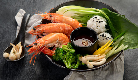 Shrimps with rice and vegetables on a dark background. Thai dish. Asian Food. Top view.の写真素材