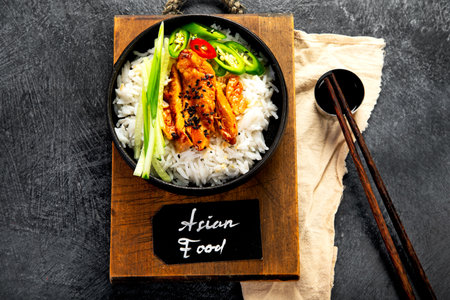 Crispy cashew Chicken stir fry with rice and vegetables on a light background. Asian dish. Top view.の写真素材