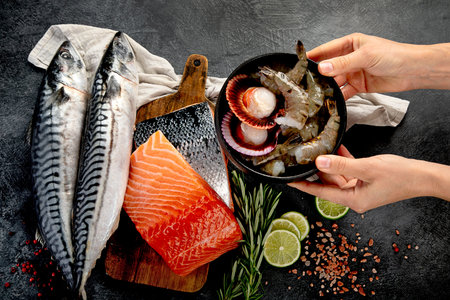 Variety of fresh seafood and herbs. Fresh fish and seafood arrangement. Top view.の写真素材