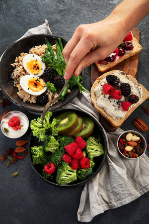 Bowls of vegan porridge with vegetables, sandwiches with fruits. Healthy eating. Top view.の写真素材