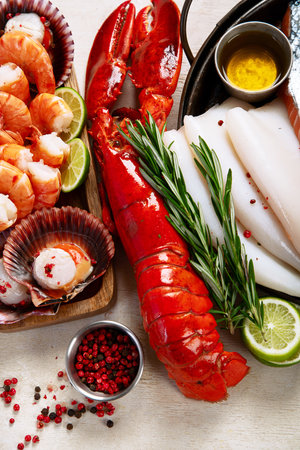 Variety of fresh seafood and herbs. Fresh fish and seafood arrangement. Top view.の写真素材