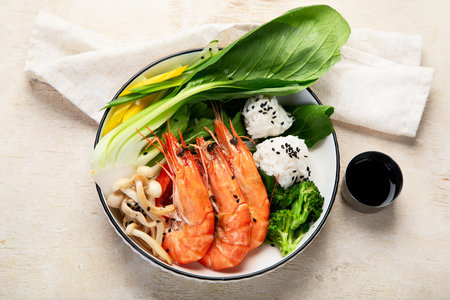 Shrimps with rice and vegetables on a light background. Thai dish. Asian Food. Top view.の写真素材