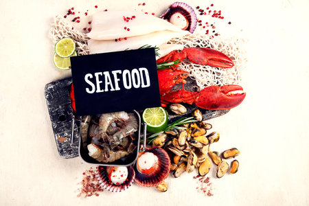 Variety of fresh seafood and herbs. Fresh fish and seafood arrangement. Top view.の写真素材