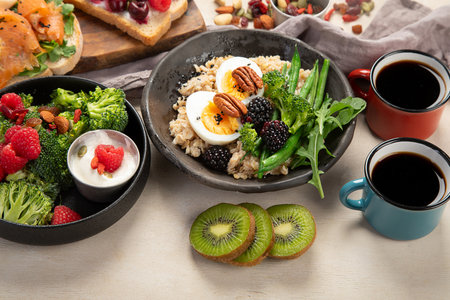 Bowls of vegan porridge with eggs and vegetables, sandwiches with fruits. Healthy eating. Top view.