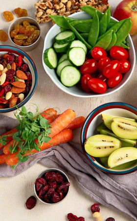 Healthy balanced dieting concept. Selection of rich fiber sources vegan food. Vegetables, fruits, seeds and nuts. Top view.の写真素材