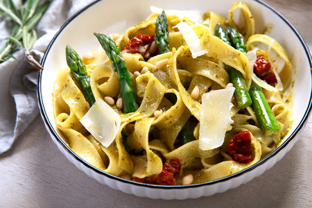 Tagliatelle with asparagus, parmesan and pine nutsの写真素材