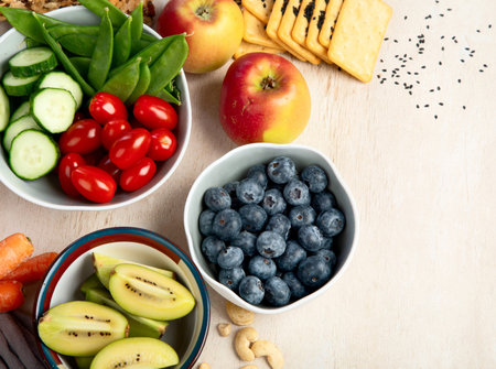 Healthy balanced dieting concept. Selection of rich fiber sources vegan food. Vegetables, fruits, seeds and nuts. Top view.の写真素材