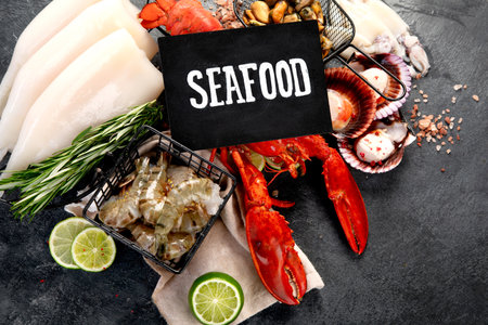 Variety of fresh seafood and herbs. Fresh fish and seafood arrangement. Top view.の写真素材