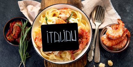 Homemade Creamy Shrimp Pasta on a Plate on a dark background. Top view.の写真素材