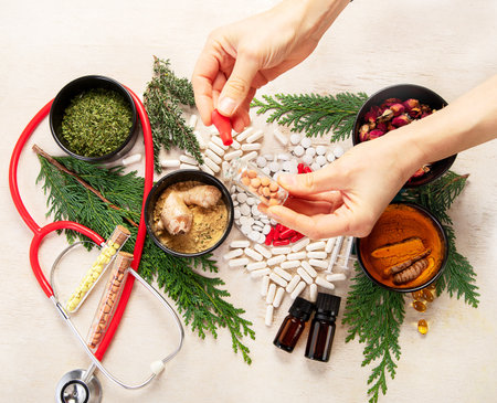 Medicinal tablets and pills and herbs composition on a light background. Top view.の写真素材