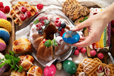 Easter or spring dessert assortment of breads, desserts and treats on a light background. Top view.