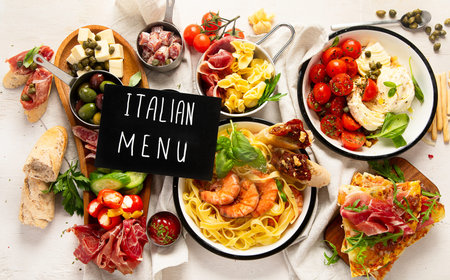 Iitalian dishes on a light background. Italian family dinner. Top view.