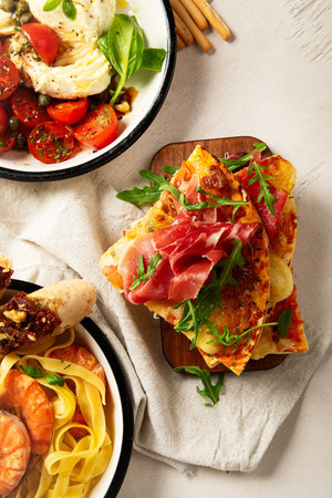 Tasty appetizers with prosciutto and mozzarella