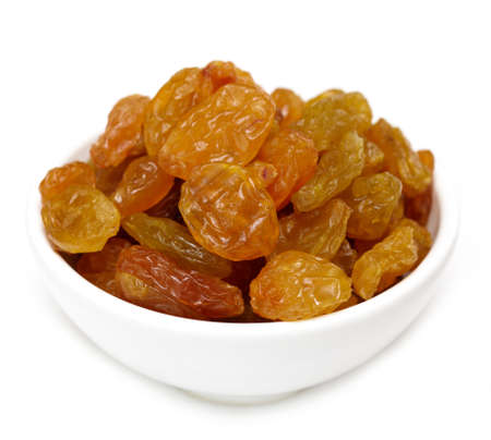 Bowl of raisins on white backgroundの写真素材