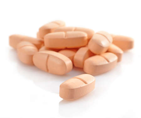Orange pills on white backgroundの写真素材