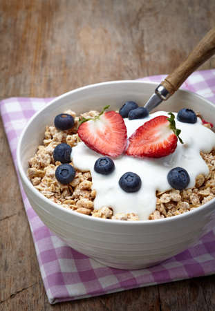 Bowl of healthy muesli with yogurt and fresh berriesの写真素材