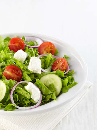 Fresh healthy salad with vegetables and goat cheeseの写真素材