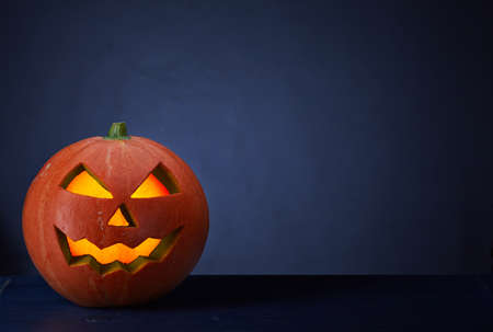 Halloween pumpkin on dark blue backgroundの写真素材