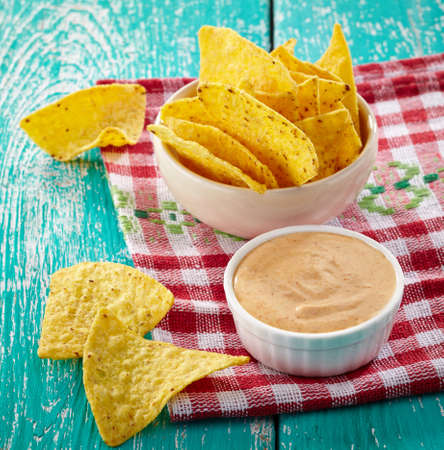Mexican nachos and dip on blue wooden backgroundの写真素材