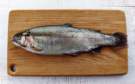 Fresh trout on wooden cutting boardの写真素材