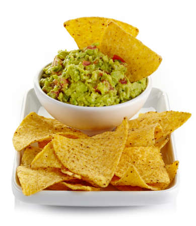 Plate of guacamole dip and nachos isolated on white backgroundの写真素材
