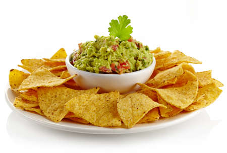 Plate of guacamole dip and nachos isolated on white backgroundの写真素材