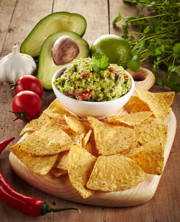 Ingredients for avocado guacamole dip and nachosの写真素材