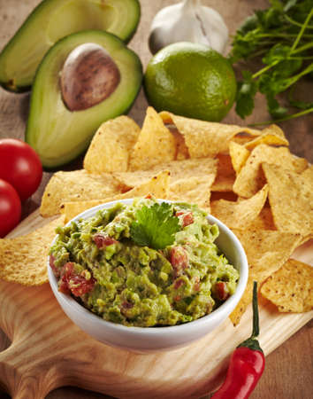 Ingredients for avocado guacamole dip and nachosの写真素材