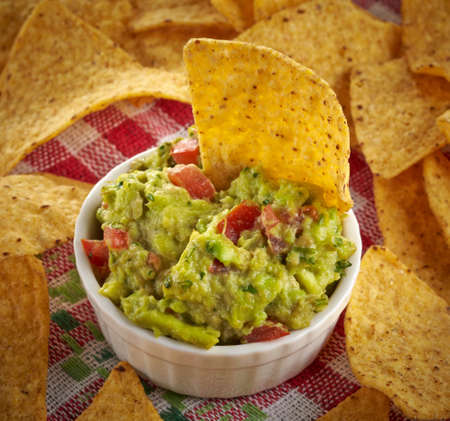 Bowl of guacamole dip and nachosの写真素材