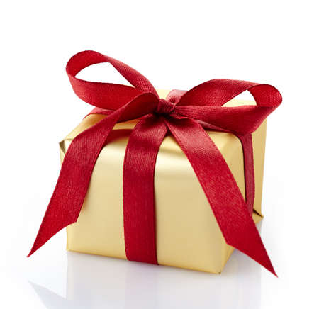 Golden gift box with red ribbon isolated on white backgroundの写真素材
