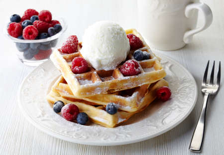 Plate of belgium waffles with fresh berries and ice creamの写真素材