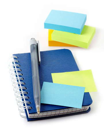 Notebook, pen and post-it notes isolated on white backgroundの写真素材
