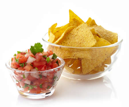 Bowl of salsa dip and nachos isolated on white backgroundの写真素材