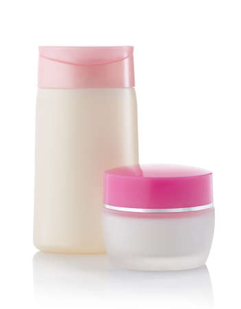 Bottle of cosmetic lotion and jar of cream isolated on white backgroundの写真素材