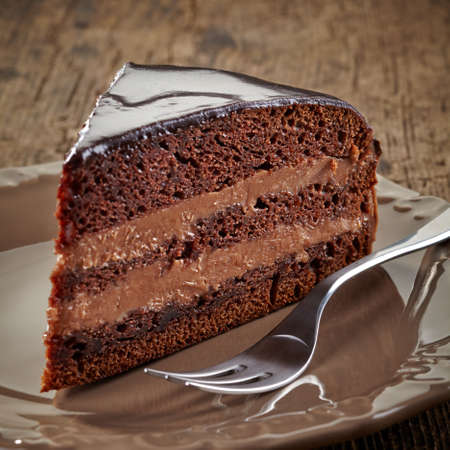 Piece of chocolate cake on wooden backgroundの写真素材