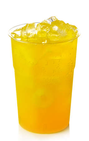 Plastic glass of orange lemonade with ice isolated on white backgroundの写真素材