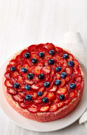 Plate of strawberry cream cake on white wooden backgroundの写真素材