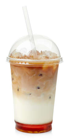 Iced coffee with caramel syrup in plastic glass isolated on white backgroundの写真素材
