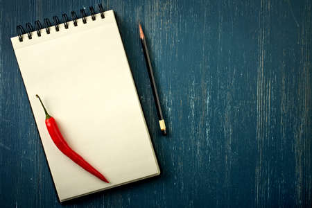 Blank recipe book and pencil on old dark blue wooden backgroundの写真素材