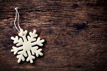 Snowflake decoration on wooden backgroundの写真素材