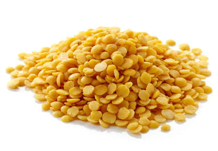 Heap of yellow indian lentils isolated on white backgroundの写真素材