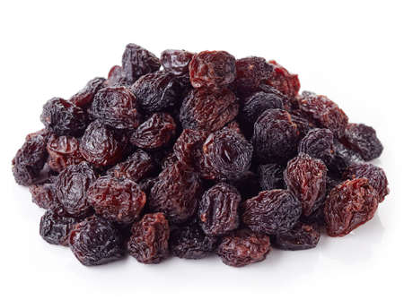 Heap of dark raisins isolated on white backgroundの写真素材