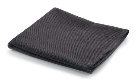 Folded black cotton napkin isolated on white backgroundの写真素材