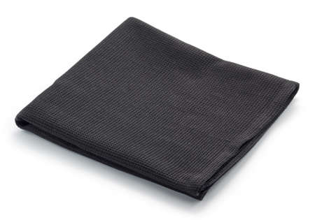 Folded black cotton napkin isolated on white backgroundの写真素材
