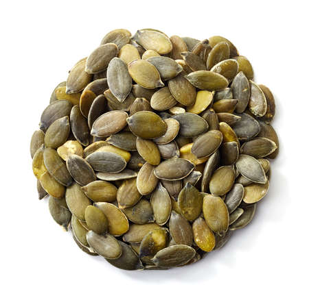 Circle of pumpkin seeds isolated on white backgroundの写真素材