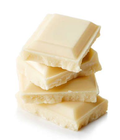 Stack of white chocolate pieces isolated on white backgroundの写真素材