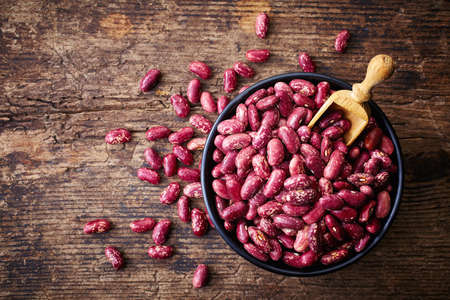 Bowl of red beans on wooden backgroundの写真素材
