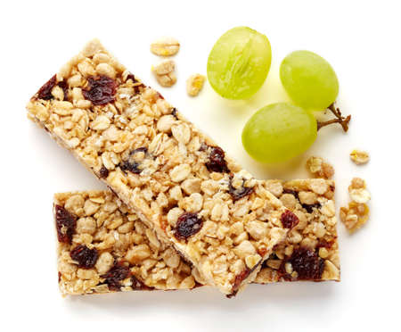 Granola bar with raisins and grapes isolated on white backgroundの写真素材