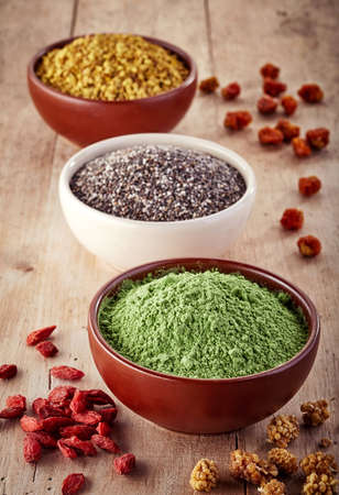Bowls of various superfood on wooden backgroundの写真素材